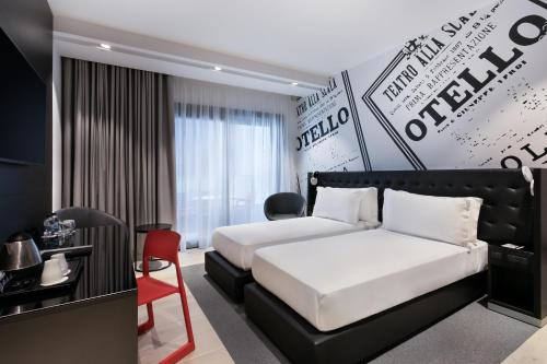 a hotel room with two beds and a desk at Verdi Gzira Promenade in Sliema