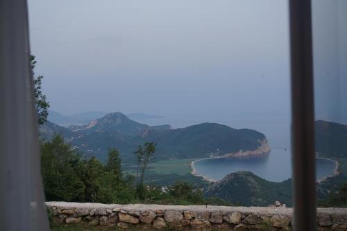a view of a lake from a window at Hill Homes Montenegro in Petrovac na Moru