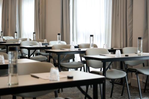 a room with tables and chairs and windows at Hotel Puerta de Toledo in Madrid