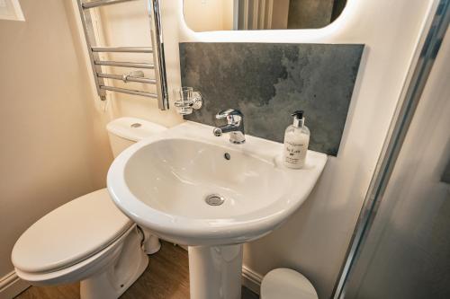 a bathroom with a sink and a toilet at Rooms at the Apple Pie in Ambleside