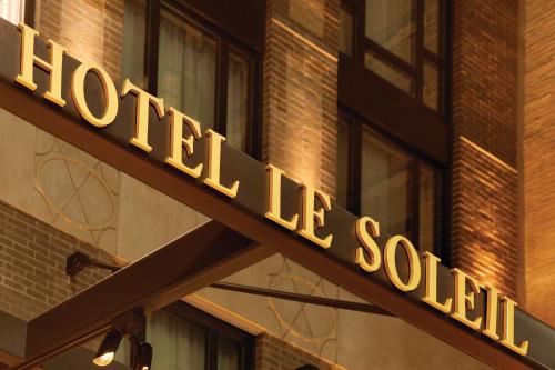 a hotel sign on the side of a building at Executive Hotel Le Soleil New York in New York