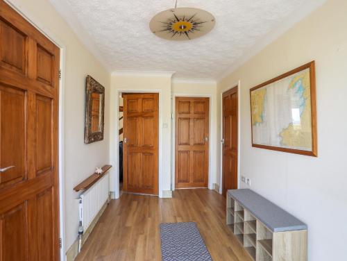 a hallway with wooden doors and a ceiling at Hafan Deg in Pwllheli