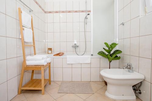 a bathroom with a toilet and a sink at Holiday House Dolin in Rab