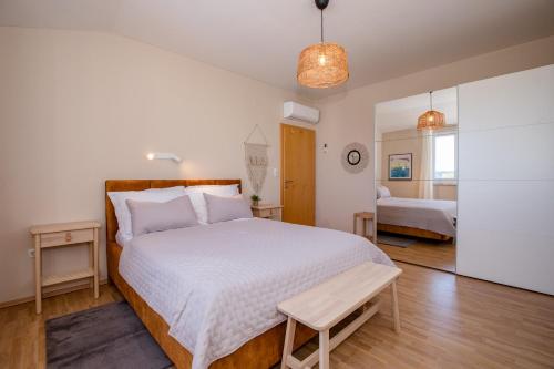 a bedroom with a large bed with a wooden headboard at Holiday House Dolin in Rab