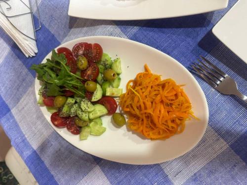 a plate of food with vegetables on a table at Hotel Skib in Tbilisi City