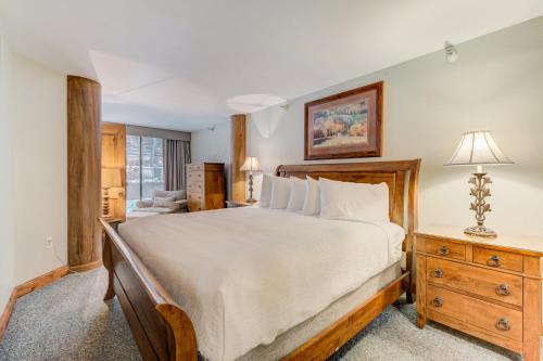 a bedroom with a large bed and a dresser at Silver King by All Seasons Resort Lodging in Park City