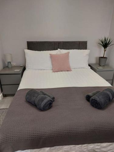 a bed with two pillows on top of it at Howard Road Home from Home in Bridport
