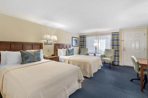 a hotel room with two beds and a desk at Juniper Hill Inn in Ogunquit