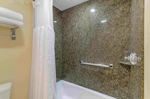 a bathroom with a shower with a tub and a toilet at Juniper Hill Inn in Ogunquit