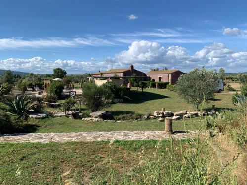 a house in the middle of a field at Resort Fonte Vulci in Canino