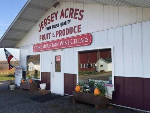 a store with a sign that reads freshasy acres fruit and produce at Charming Hammock by the River in Cressona