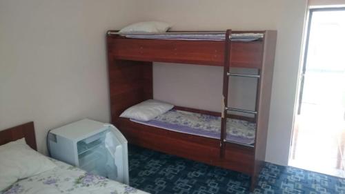 a room with two bunk beds and a tv at Акватель Aquatel in Akshi