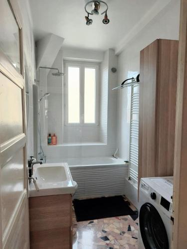 une salle de bain blanche avec une baignoire et un lavabo dans l'établissement Wellcome to K&A, à Besançon