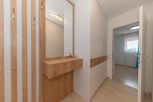 a bathroom with a sink and a mirror at Petrovac Bay Apartments in Petrovac na Moru