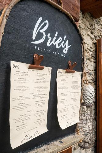 a sign for a biryani restaurant on a wall at Brieis Relais Alpino in Marmora