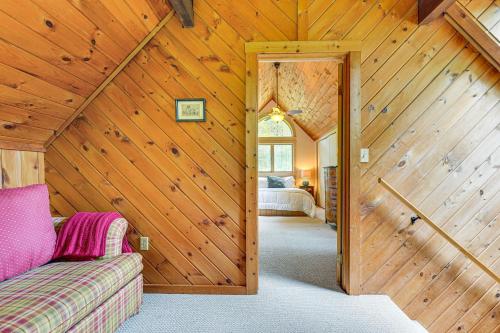 a bedroom with wooden walls and a room with a bed at Family-Friendly Ludlow Cabin on Lake Pauline! in Ludlow