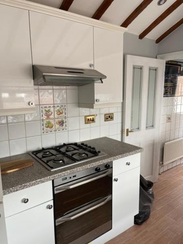 a kitchen with a stove and a counter top at Bike Park View in Merthyr Tydfil