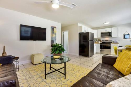 a living room with a couch and a table at Coconut Cove Mid-long term stays available Walk to Downtown Trolly to BEACHES in Sarasota