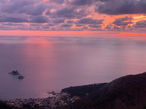 a view of the ocean at sunset at Hill Homes Montenegro in Petrovac na Moru
