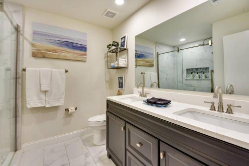 a bathroom with a sink and a toilet at Coconut Cove Mid-long term stays available Walk to Downtown Trolly to BEACHES in Sarasota