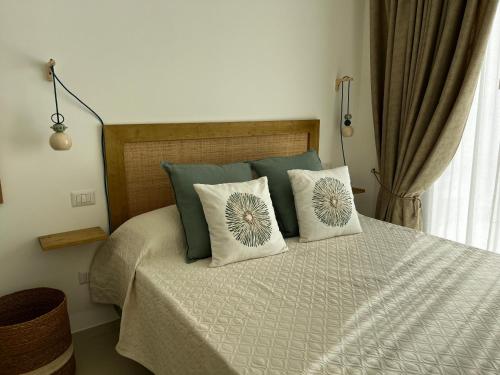 a bedroom with a bed with two pillows on it at Casita in Santo Spirito