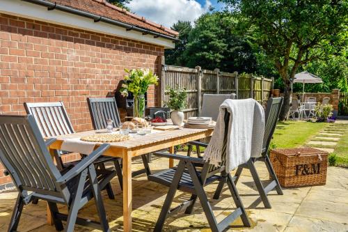 a wooden table and chairs in a backyard at The Birdie in York