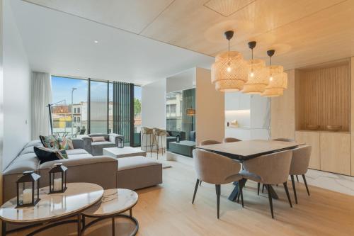 a living room with a couch and a table at Chic Two-Bedroom En Suite in Central Town - Savoy Residence in Funchal