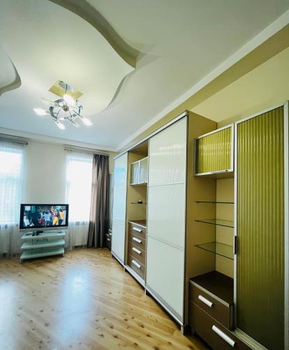 a living room with a television and a large closet at Iren Politech apartment in Lviv