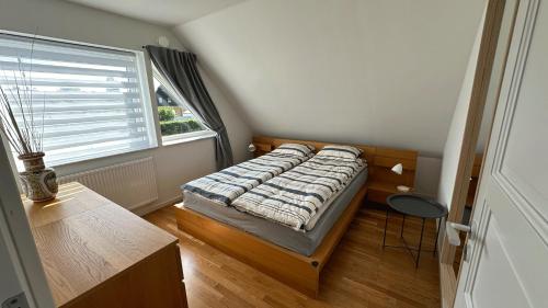a small bedroom with a bed and a window at Cozy Villa apartment in Malmö