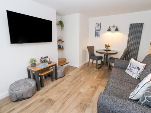 a living room with a couch and a table at Sea View Terrace in Conwy