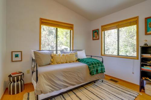 a bedroom with a bed and two windows at Idyllwild Cabin with Deck and Tahquitz Peak Views in Pine Cove