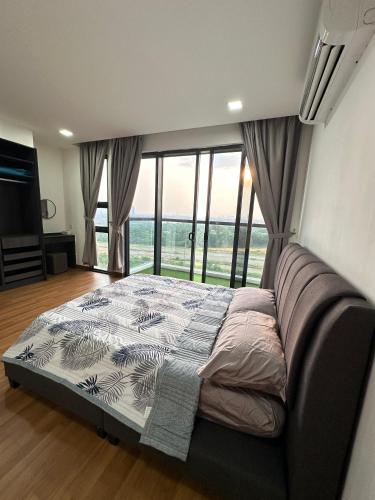 a bedroom with a bed and a large window at Sunset View Condo Cyberjaya in Cyberjaya