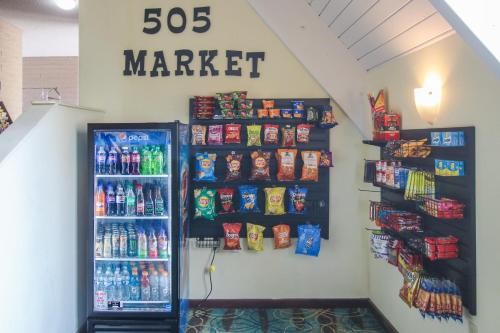 a grocery store with a refrigerator and drinks on the wall at Hotel 505 in Albuquerque