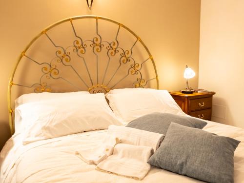 a bedroom with a large white bed with white pillows at Dimora del Padre Provile 1244 - Centro storico in LʼAquila