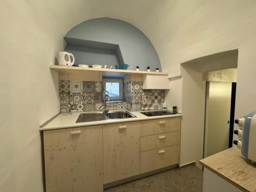 a kitchen with a sink and a window at la casa di NU in Bisceglie