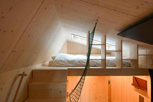 a tree house with a hammock in the middle at Tiny House Pioneer 10 - Green Tiny Village Harz in Osterode