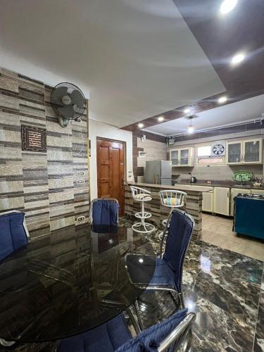 a living room with a glass table and chairs at Golden Panorama in Marsa Matruh