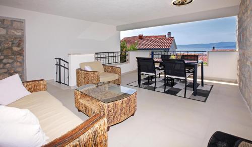 a living room with a couch and a table on a balcony at Apartment Vanja in Bol
