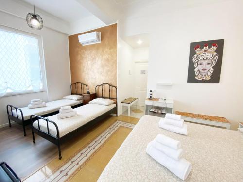 a living room with two beds and a table at Casa Granatelli in Palermo