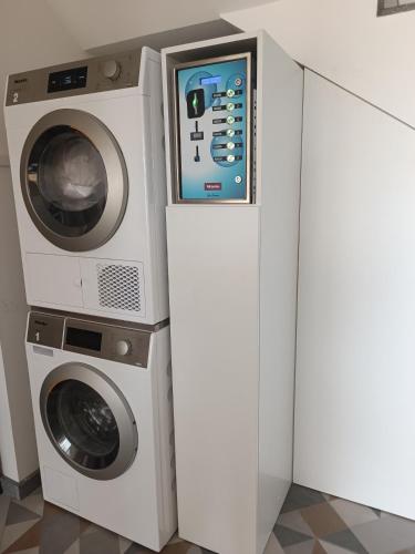 a washing machine and a dryer in a room at Cachinnans Hostel & Apartments in Vila do Conde