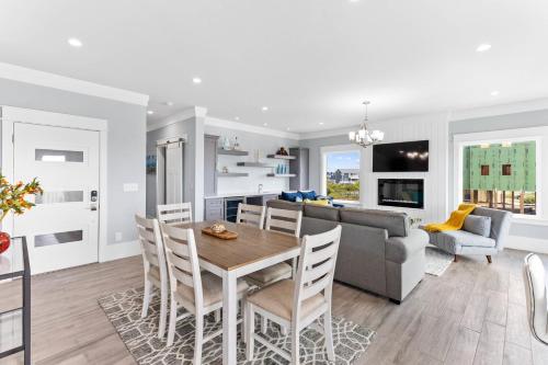 a kitchen and living room with a table and a couch at Dune Our Thing North Topsail Beach in North Topsail Beach