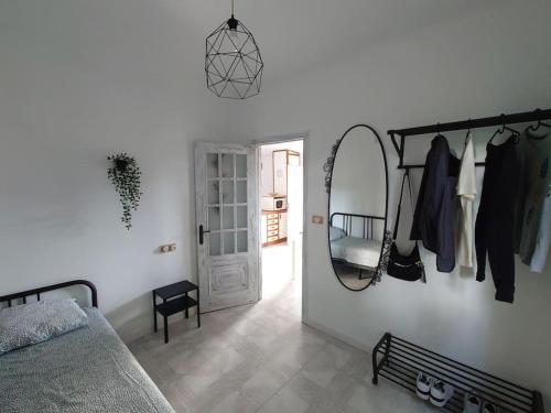 a bedroom with a bed and a mirror and a door at Casita tranquila, con finca y cerca de las playas in Muxia