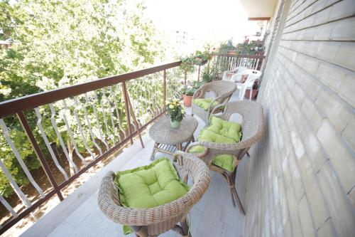 a balcony with chairs and tables on a patio at G & B House in Bari