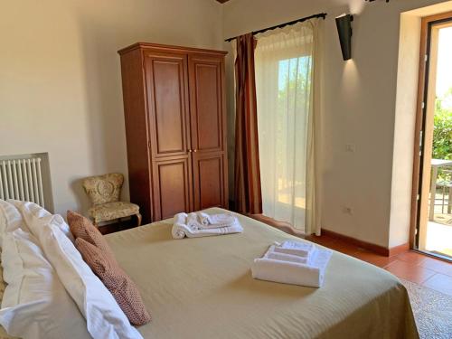 a bedroom with a bed with two towels on it at Resort Fonte Vulci in Canino