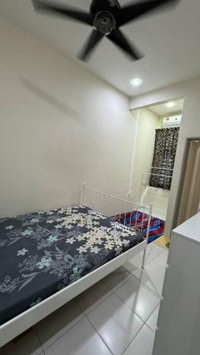 a bedroom with a bed with a black ceiling fan at Homestay Bagan Serai in Bagan Serai