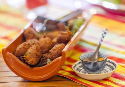 a container of food sitting on a table with a spoon at Plaine et Colline Chambres et table d'hôtes Isère in Gillonnay