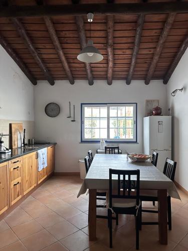 a kitchen and dining room with a table and chairs at Wine under the Stars in Reguengos de Monsaraz
