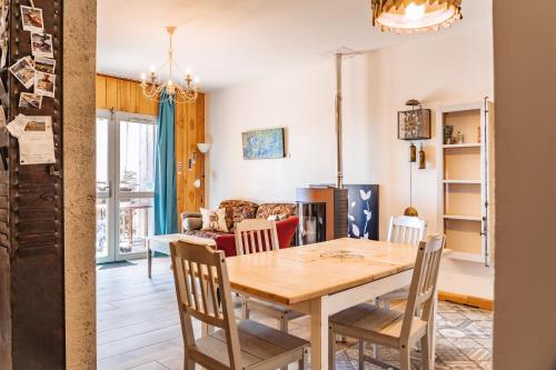 a dining room and living room with a table and chairs at Gites La Boletiere in Saint-Étienne-du-Valdonnez