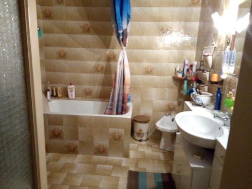 une salle de bain avec une baignoire et un lavabo dans l'établissement Maison de village, à Les Cammazes