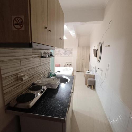 a kitchen with a sink and a counter top at Sweet Home in Karterados